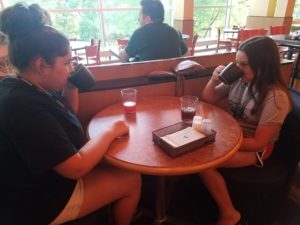Sisters Natasha (right) and Shea (left) Vatalaro start their morning at MIPA by having breakfast together. The sisters have come to the summer workshop to learn about visual components of publications.