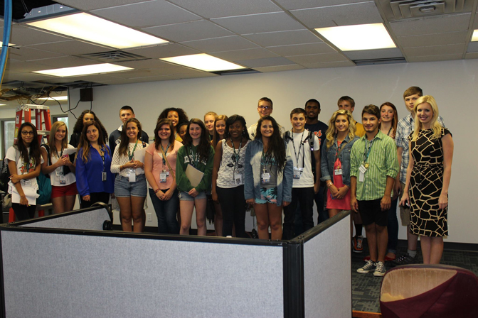 Students in the "Smile, You're on Camera" class at the MIPA Summer Workshop pose with WILX News anchor Lauren Evans. The students watched Evans live on set and then received a tour of the studio. Angel Yerena/Photo