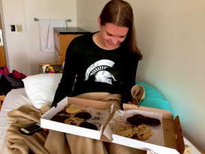 Senior Esther Seawell enjoys the remains of an Insomnia Cookies “Major Rager” in her dorm room.  Kelly Martinek/ Photo.
