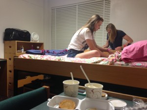 Students Maggie Sehaller and Megan Pizarczyk lounge in their rearranged dorm room.  The dorm was originally set up with beds in each corner of the room and furniture stored underneath the beds.